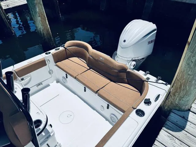 Slide: The Image of 2024 Sea Hunt Ultra 239 SE boat with Yamaha outboard engine, featuring spacious seating. - 10