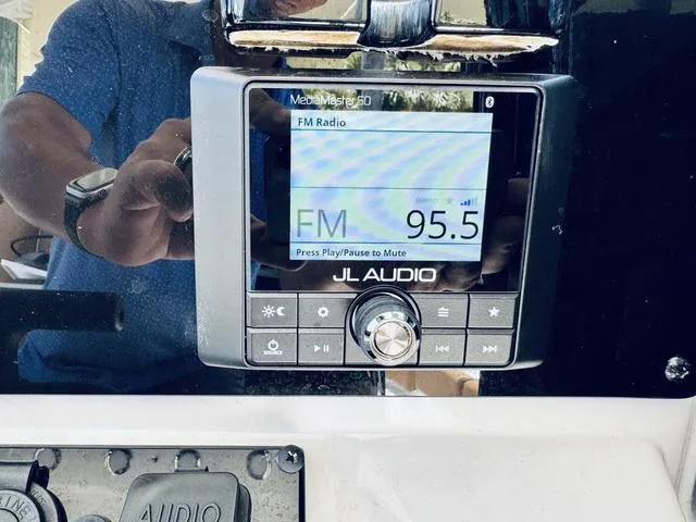 Slide: The Image of JL Audio MediaMaster 50 displaying FM radio on Sea Hunt Ultra 239 SE, 2024 model. - 17