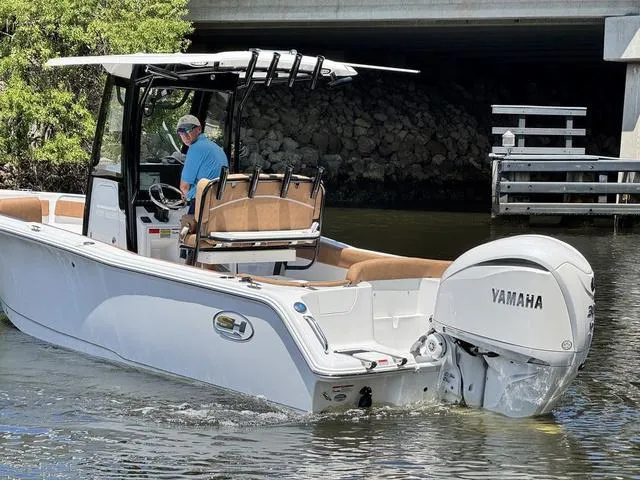 Slide: The Image of 2024 Sea Hunt Ultra 239 SE boat with Yamaha engine on water. - 20