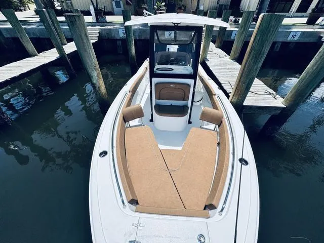 Slide: The Image of 2024 Sea Hunt Ultra 239 SE boat docked, featuring spacious seating and sleek design. - 29