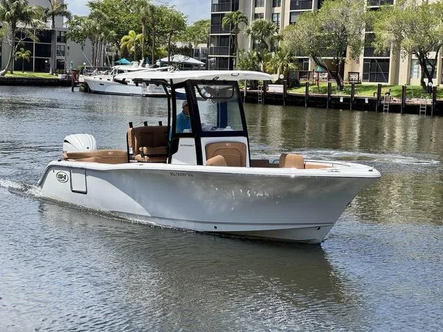 Slide: The Image of 2024 Sea Hunt Ultra 239 SE boat cruising on a calm waterway. - 3