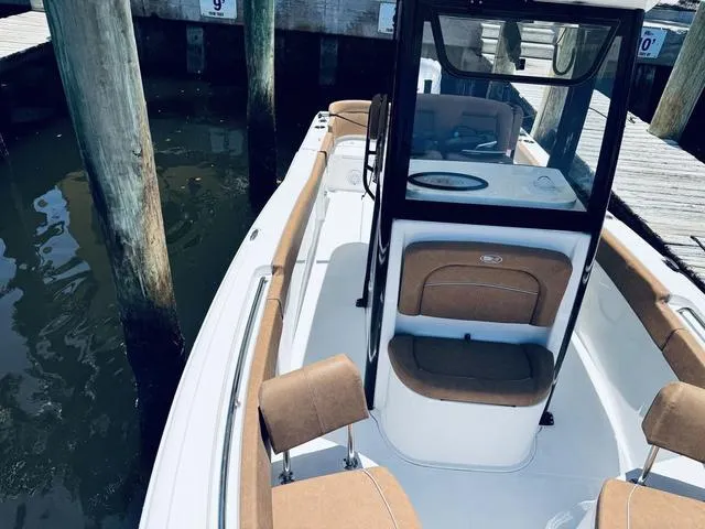 Slide: The Image of 2024 Sea Hunt Ultra 239 SE boat docked, featuring sleek design and comfortable seating. - 30