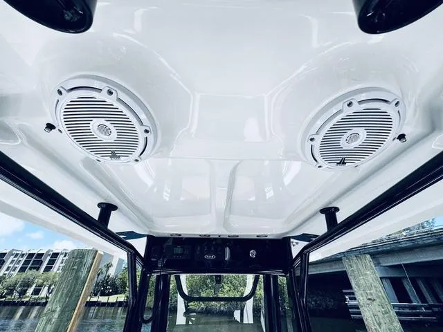 Slide: The Image of 2024 Sea Hunt Ultra 239 SE boat interior with ceiling speakers and control panel. - 33