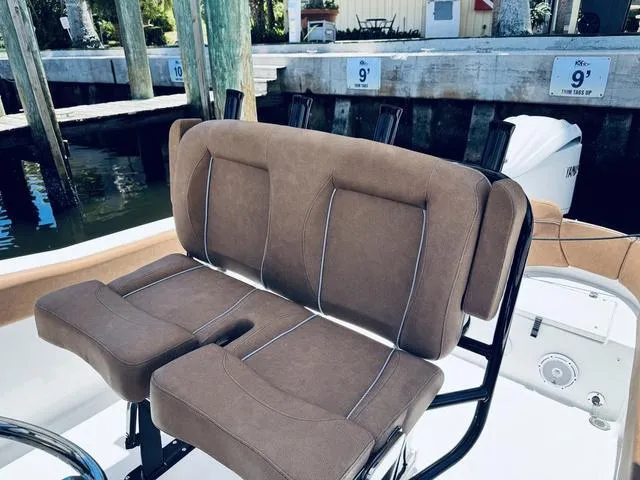 Slide: The Image of 2024 Sea Hunt Ultra 239 SE boat seating, featuring comfortable brown cushions and sleek design. - 5