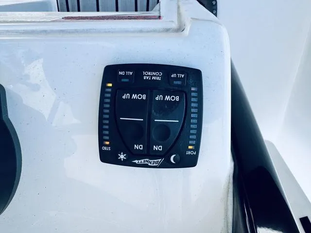 Slide: The Image of 2024 Sea Hunt Ultra 239 SE trim tab control panel. - 8