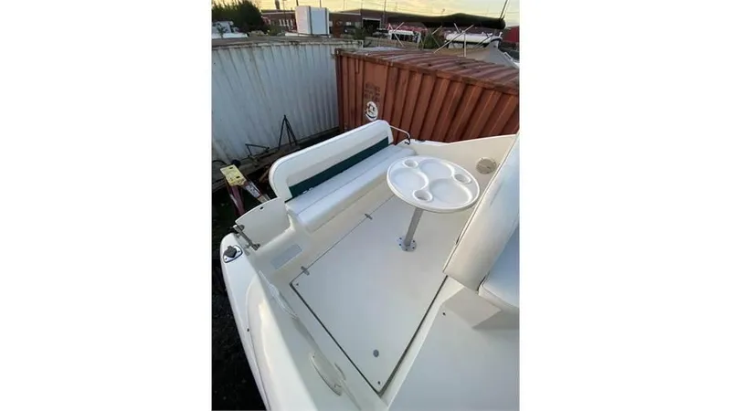 Slide: The Image of 1997 Rinker 266 Fiesta Vee boat deck with seating and table. - 12