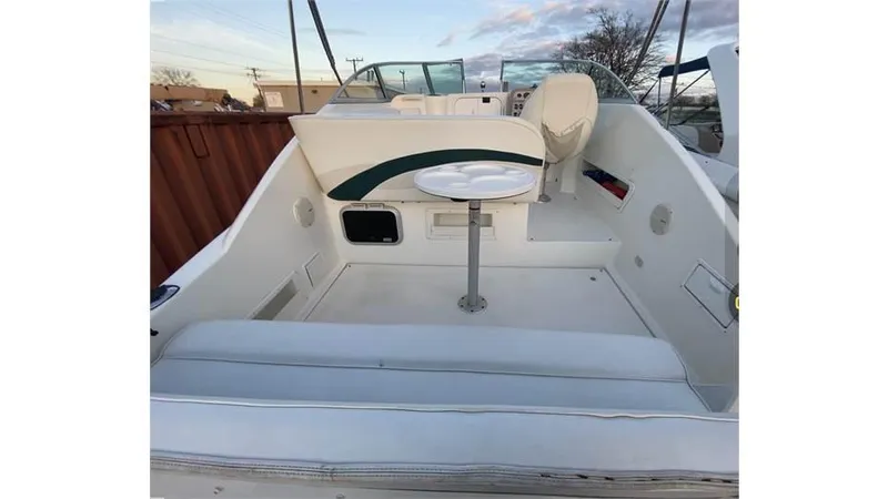 Slide: The Image of 1997 Rinker 266 Fiesta Vee boat interior with seating and table. - 13