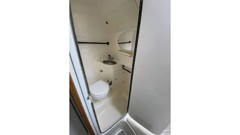Slide: The Image of 1997 Rinker 266 Fiesta Vee boat bathroom with toilet and sink. - 20