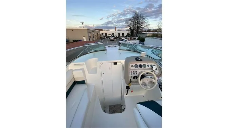 Slide: The Image of 1997 Rinker 266 Fiesta Vee boat cockpit with steering wheel and control panel. - 9