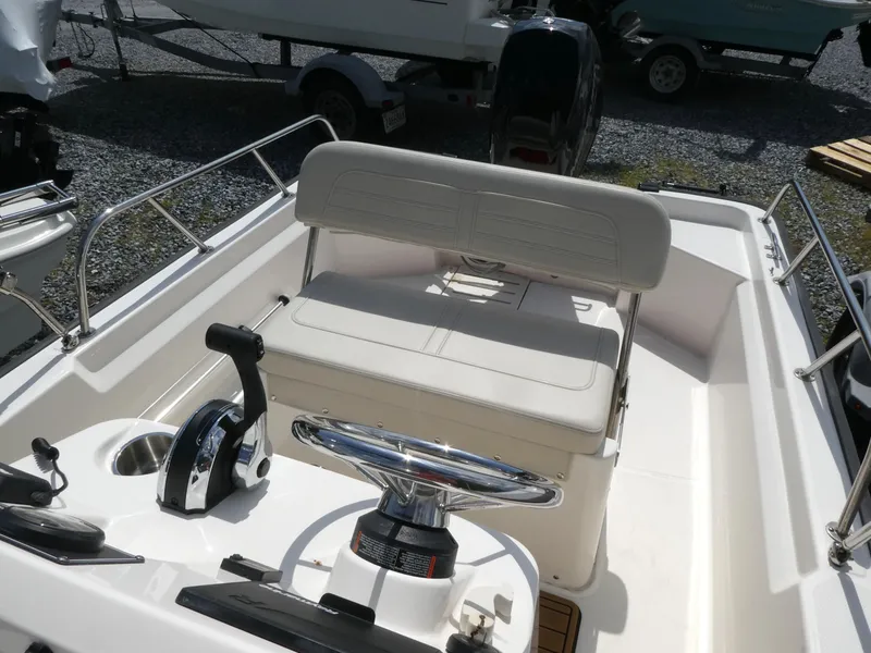 Slide: The Image of 2022 Boston Whaler 150 Montauk boat interior with steering console and seating. - 7