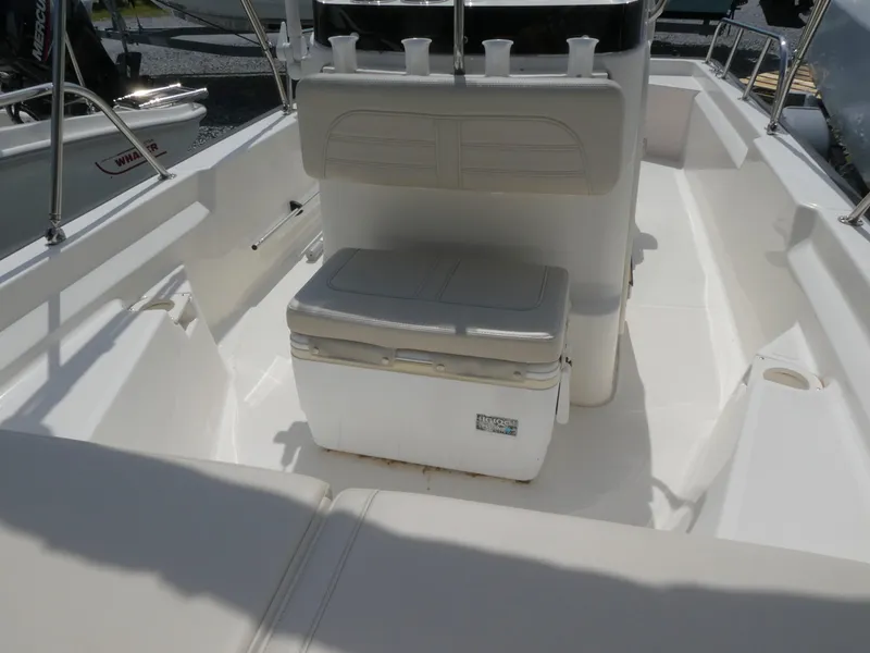 Slide: The Image of 2022 Boston Whaler 150 Montauk interior with seating and storage. - 9