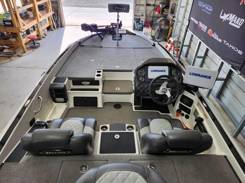 Slide: The Image of 2016 Triton 20 TRX boat interior with Lowrance electronics, dual seats, and steering console. - 11