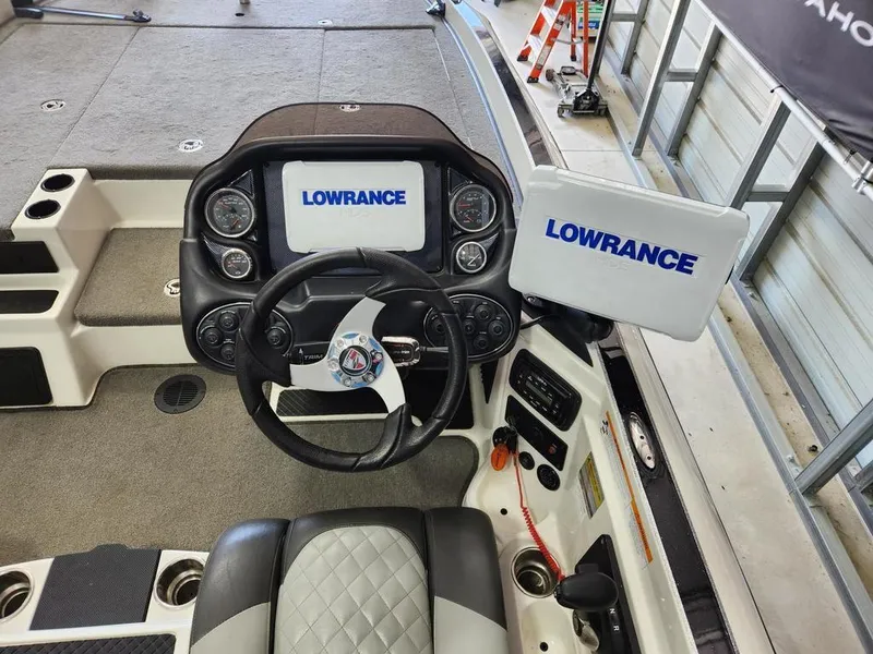 Slide: The Image of 2016 Triton 20 TRX boat dashboard with Lowrance electronics and steering wheel. - 12