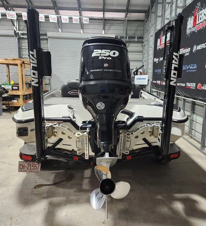 Slide: The Image of 2016 Triton 20 TRX boat with 250 Pro engine in a garage setting. - 2
