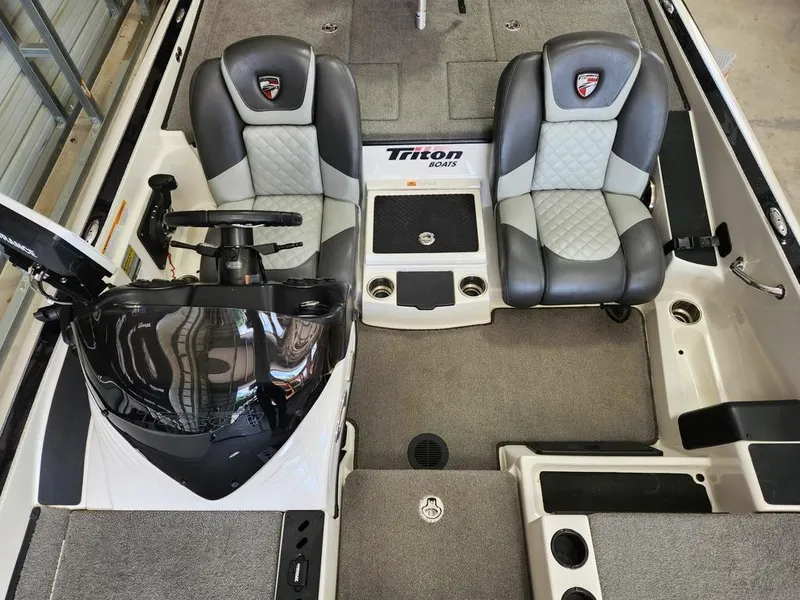 Slide: The Image of 2016 Triton 20 TRX boat interior with dual seats and steering console. - 8
