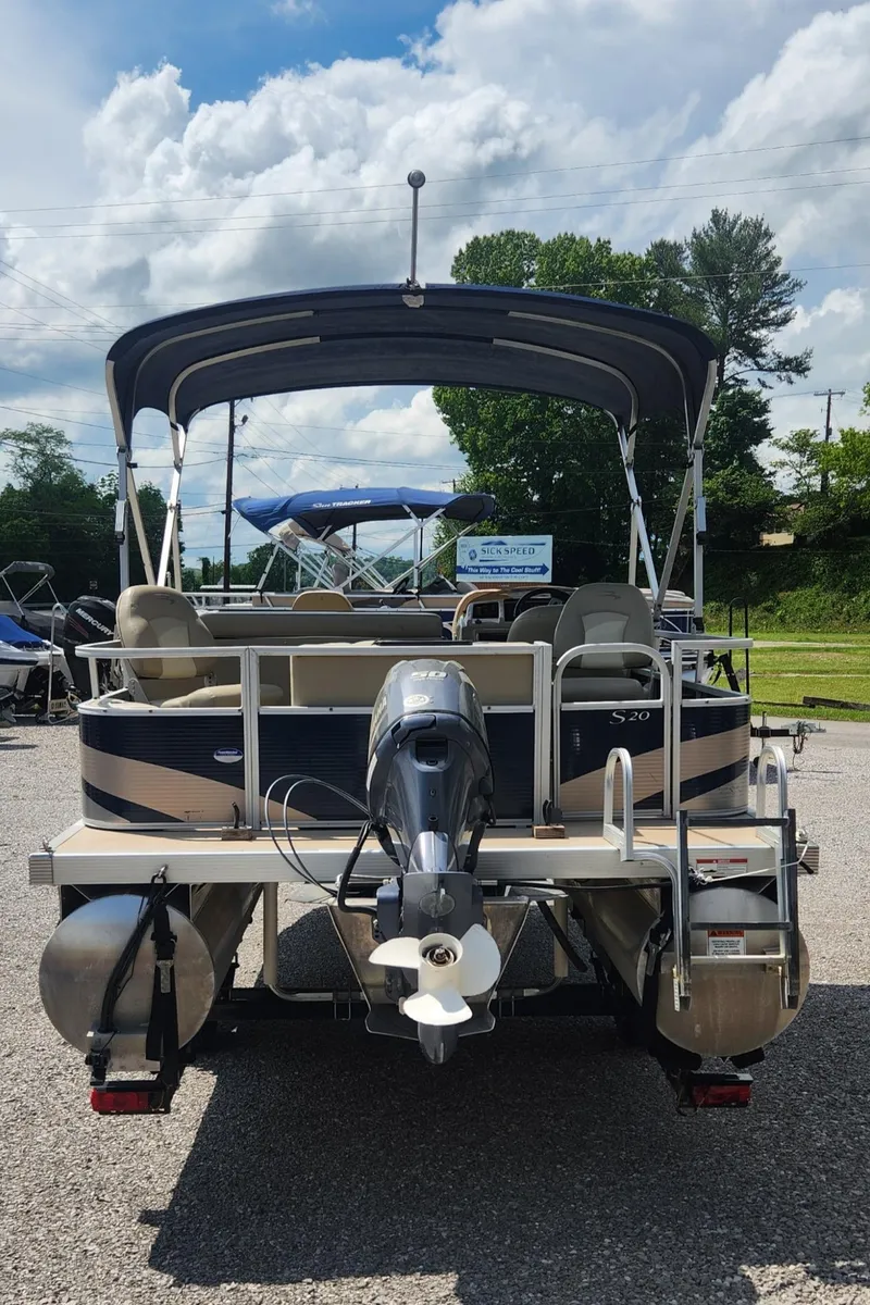 Slide: The Image of 2014 Bennington 20 SF pontoon boat with canopy, rear view, parked outdoors. - 3