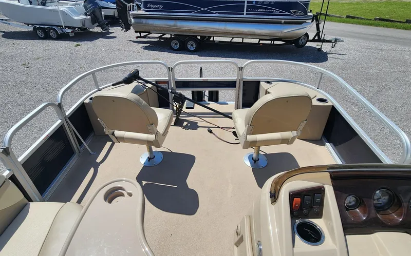Slide: The Image of 2014 Bennington 20 SF pontoon boat interior with two swivel seats and control panel. - 5