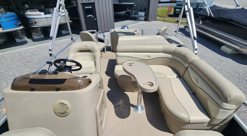 Slide: The Image of 2014 Bennington 20 SF pontoon boat with beige seating and steering console. - 6