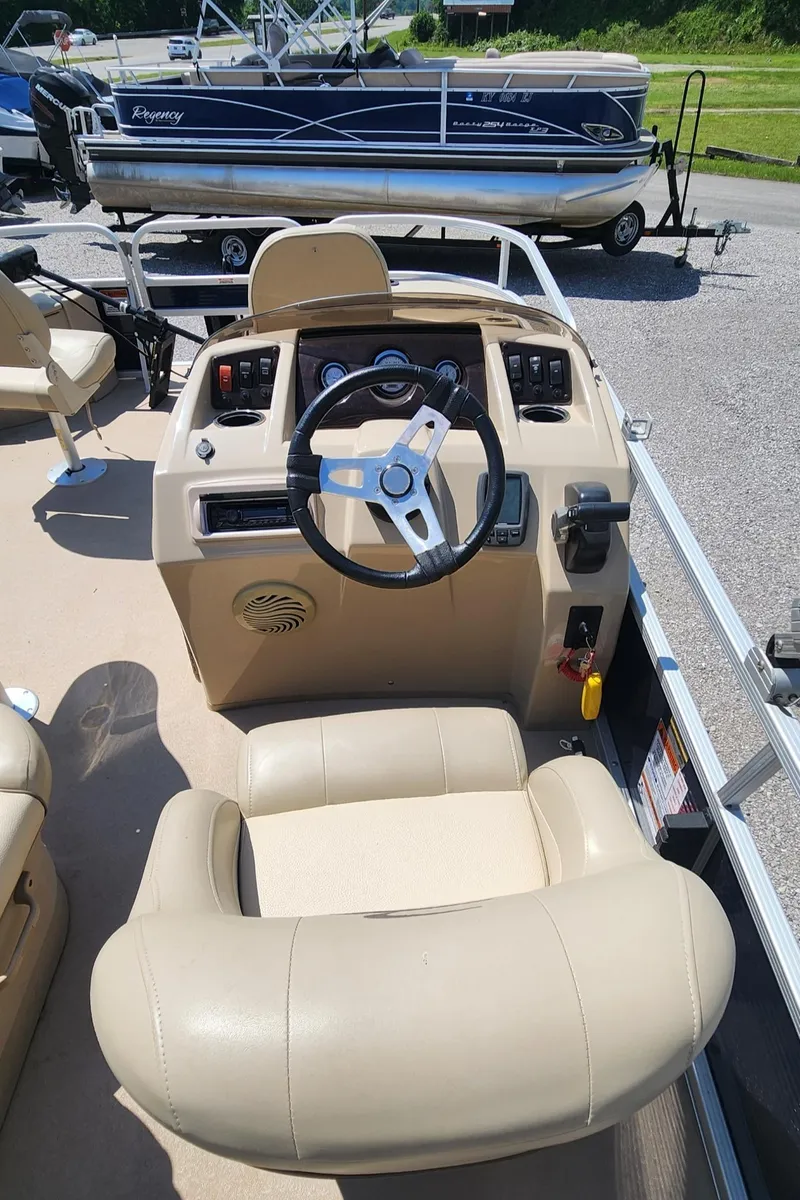 Slide: The Image of 2014 Bennington 20 SF boat interior with steering wheel and control panel. - 7