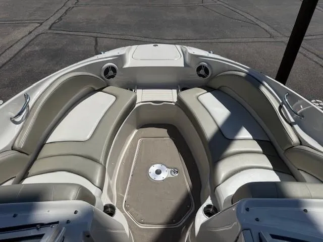 Slide: The Image of 2006 Sea Ray 220 Sundeck boat interior with cushioned seating and speakers. - 11