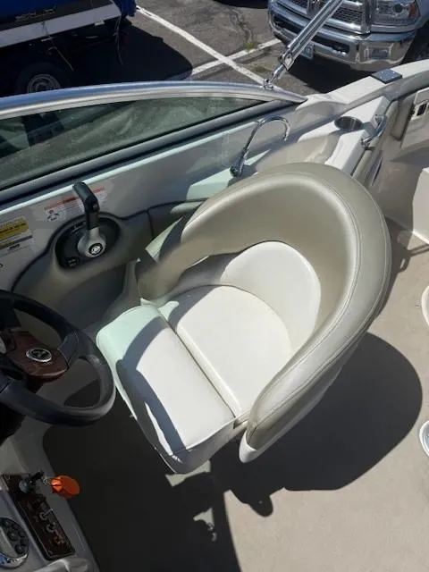Slide: The Image of Captain's seat of a 2006 Sea Ray 220 Sundeck boat, featuring a sleek design. - 12