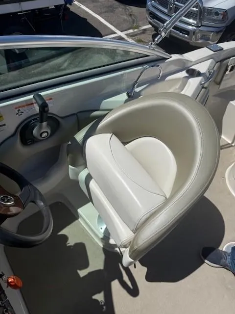 Slide: The Image of Captain's seat on a 2006 Sea Ray 220 Sundeck boat, featuring a steering wheel and controls. - 13