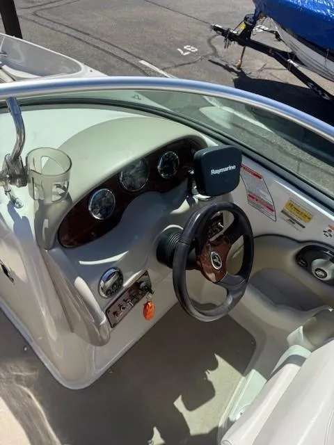 Slide: The Image of 2006 Sea Ray 220 Sundeck boat dashboard with steering wheel and navigation system. - 14