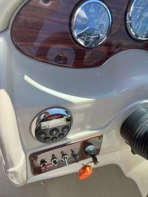 Slide: The Image of 2006 Sea Ray 220 Sundeck dashboard with gauges and controls. - 15