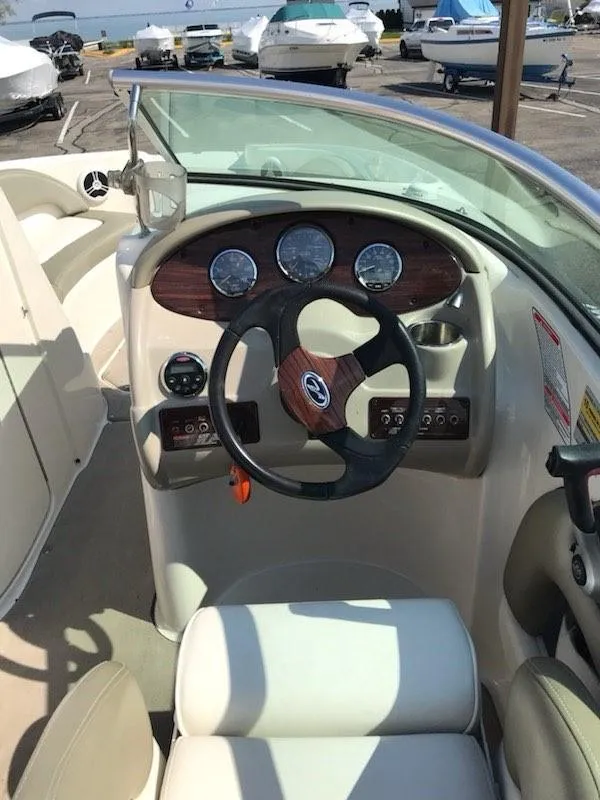 Slide: The Image of 2006 Sea Ray 220 Sundeck boat dashboard with steering wheel and gauges. - 17