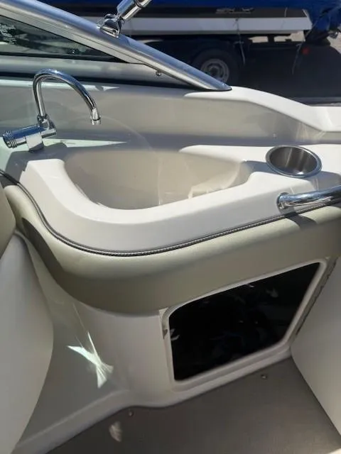 Slide: The Image of 2006 Sea Ray 220 Sundeck boat interior with sink and cup holder. - 19