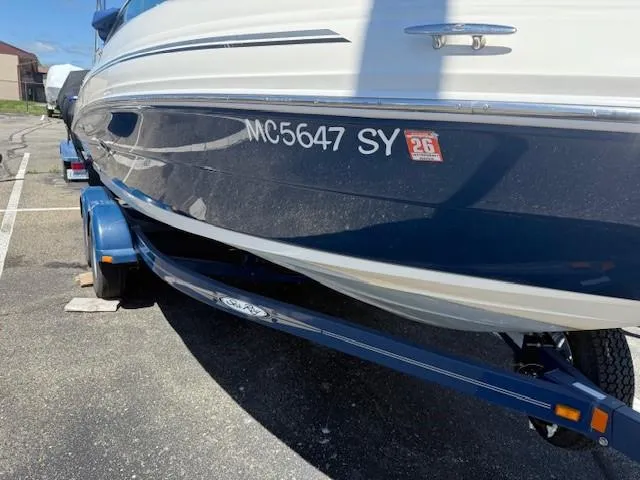 Slide: The Image of 2006 Sea Ray 220 Sundeck boat on trailer, parked in a lot. - 2