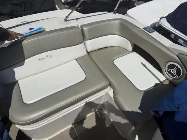 Slide: The Image of 2006 Sea Ray 220 Sundeck boat seating area with beige and white upholstery. - 20