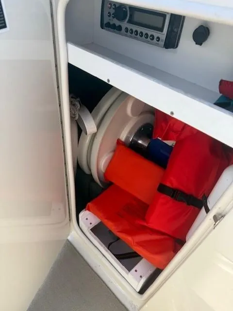 Slide: The Image of Storage compartment in a 2006 Sea Ray 220 Sundeck with life jackets and equipment. - 21