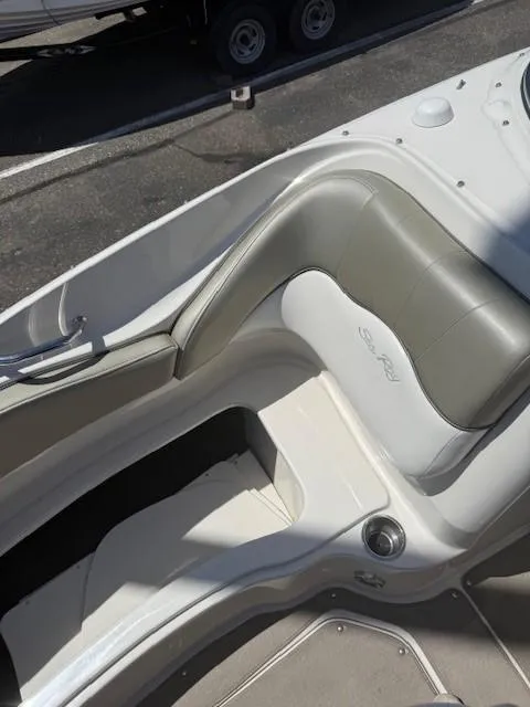 Slide: The Image of 2006 Sea Ray 220 Sundeck boat interior with gray and white seating. - 23