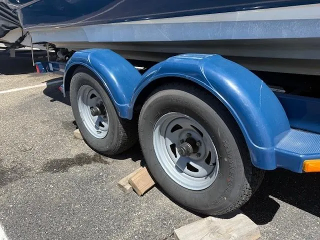 Slide: The Image of Trailer wheels of a 2006 Sea Ray 220 Sundeck boat on wooden blocks. - 29