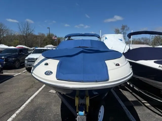Slide: The Image of 2006 Sea Ray 220 Sundeck boat with blue cover in parking lot. - 3