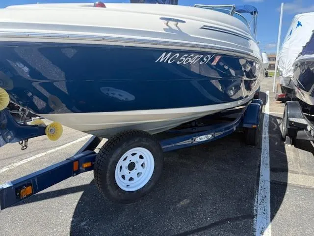 Slide: The Image of 2006 Sea Ray 220 Sundeck boat on trailer in parking lot. - 4