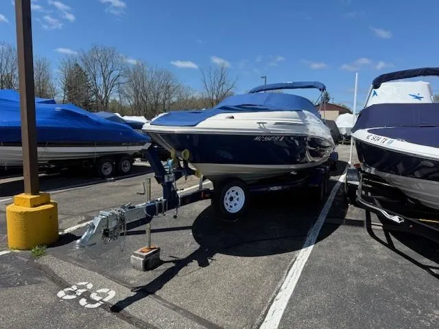 Slide: The Image of 2006 Sea Ray 220 Sundeck boat on trailer in parking lot, covered and ready for transport. - 5