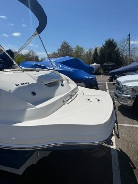 Slide: The Image of 2006 Sea Ray 220 Sundeck boat in parking lot, sunny day, blue sky. - 9