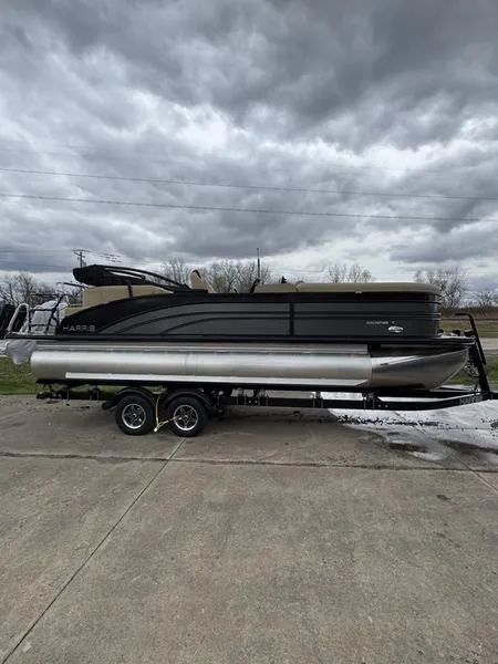 Slide: The Image of 2025 Harris Sunliner 230 pontoon boat on trailer under cloudy sky. - 0