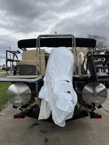 Slide: The Image of 2025 Harris Sunliner 230 pontoon boat, rear view, covered engine, overcast sky. - 5