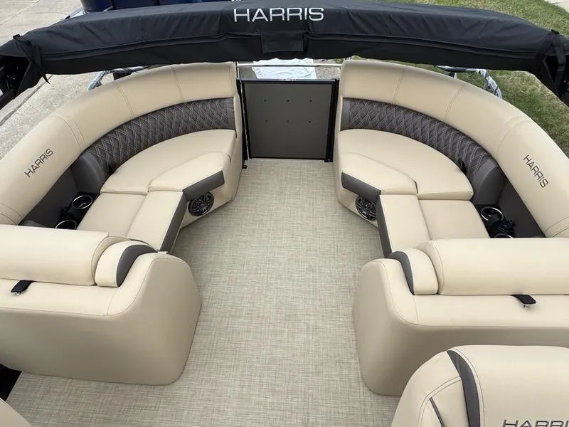 Slide: The Image of 2025 Harris Sunliner 230 boat interior with beige seating and black accents. - 7