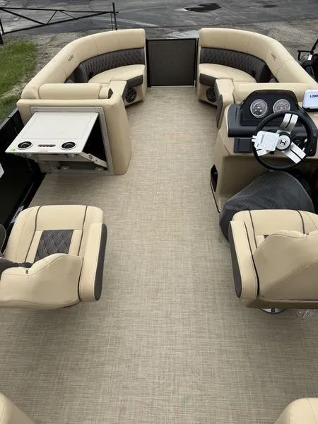 Slide: The Image of 2025 Harris Sunliner 230 pontoon boat interior with beige seating and modern dashboard. - 8