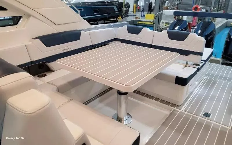 Slide: The Image of 2025 Formula 400 Super Sport Crossover yacht interior with sleek seating and table design. - 11