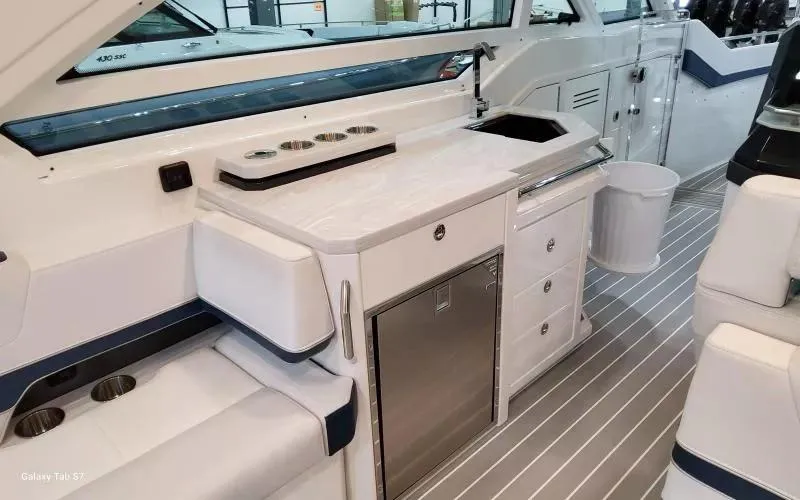 Slide: The Image of 2025 Formula 400 Super Sport Crossover yacht interior with kitchenette and seating area. - 15