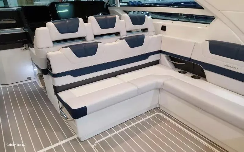 Slide: The Image of 2025 Formula 400 Super Sport Crossover interior with luxurious white and navy seating. - 16