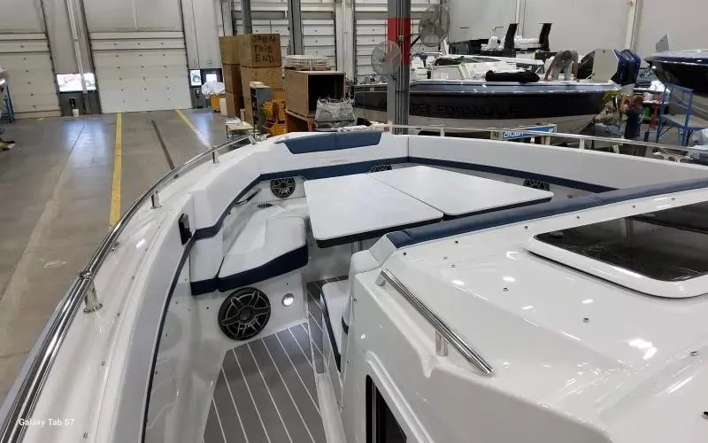 Slide: The Image of 2025 Formula 400 Super Sport Crossover boat interior with seating and table in a workshop. - 21