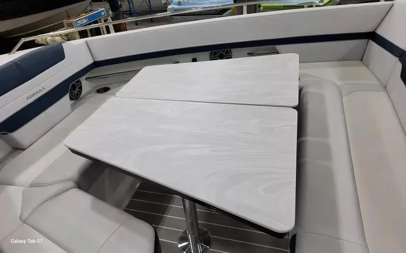 Slide: The Image of 2025 Formula 400 Super Sport Crossover boat interior with sleek seating and modern table design. - 23