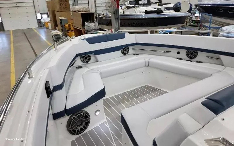 Slide: The Image of 2025 Formula 400 Super Sport Crossover boat interior with white and blue seating. - 24