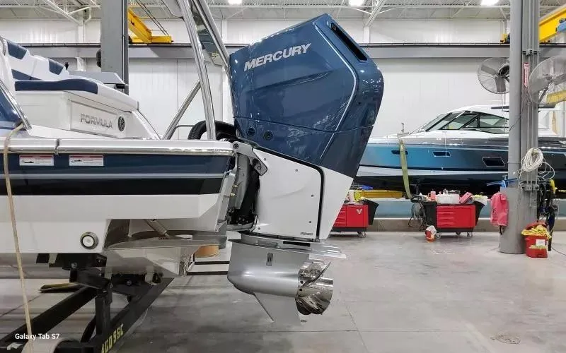 Slide: The Image of 2025 Formula 400 Super Sport Crossover with Mercury outboard engine in a boat workshop. - 4